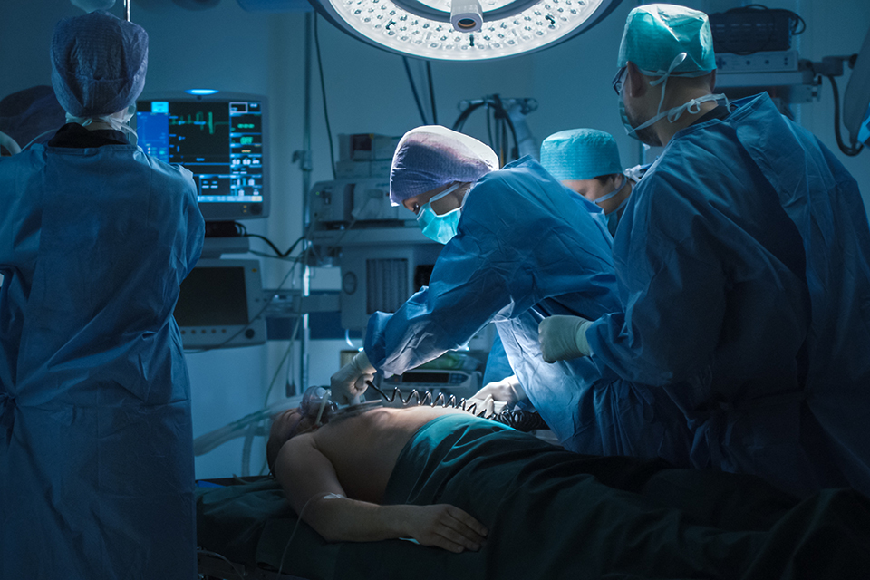 Medical Team Performing Defibrillation in Operating Room